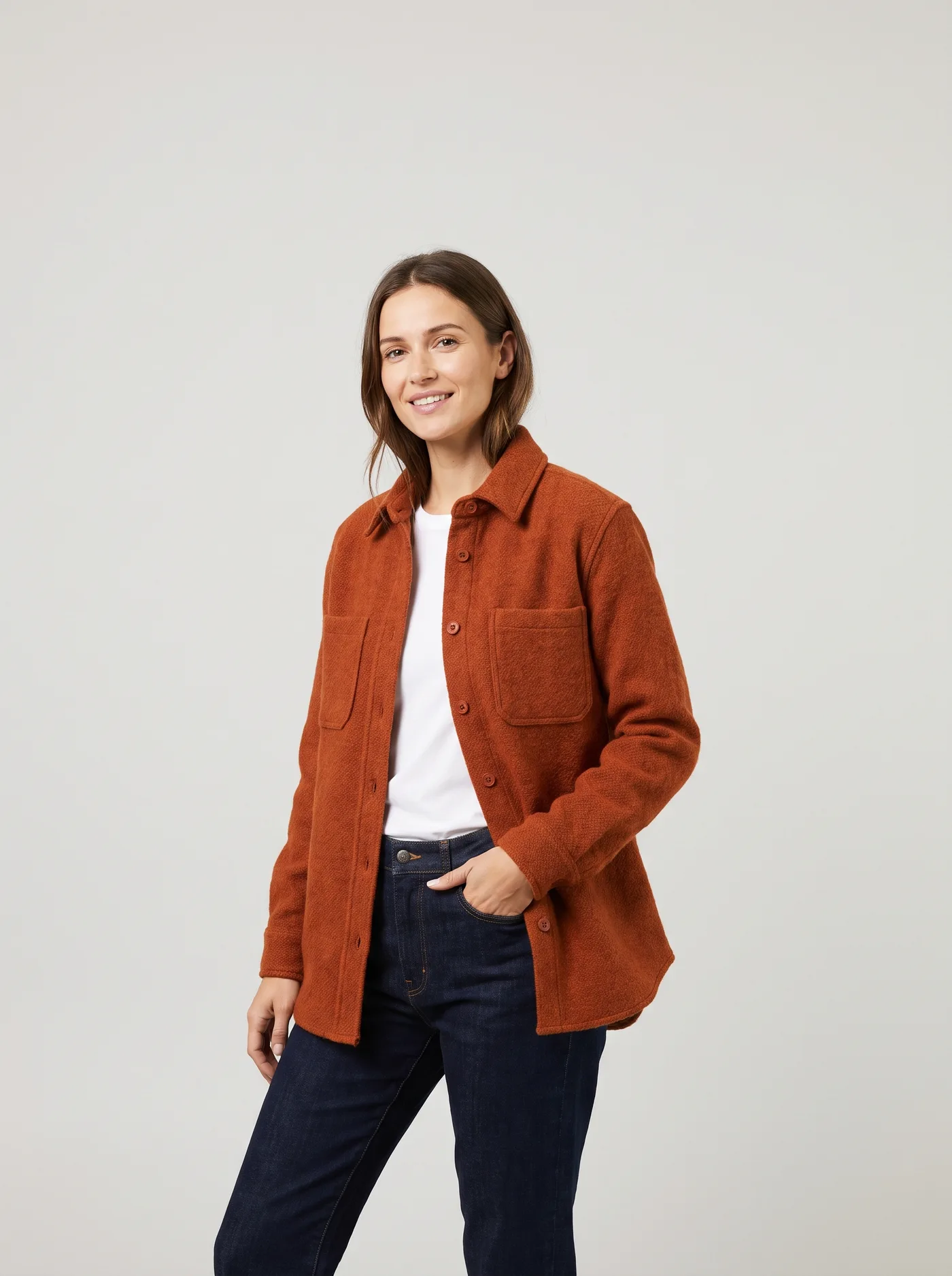 AI-generated e-commerce photo of a model in a rust-orange wool overshirt against a plain grey studio background.