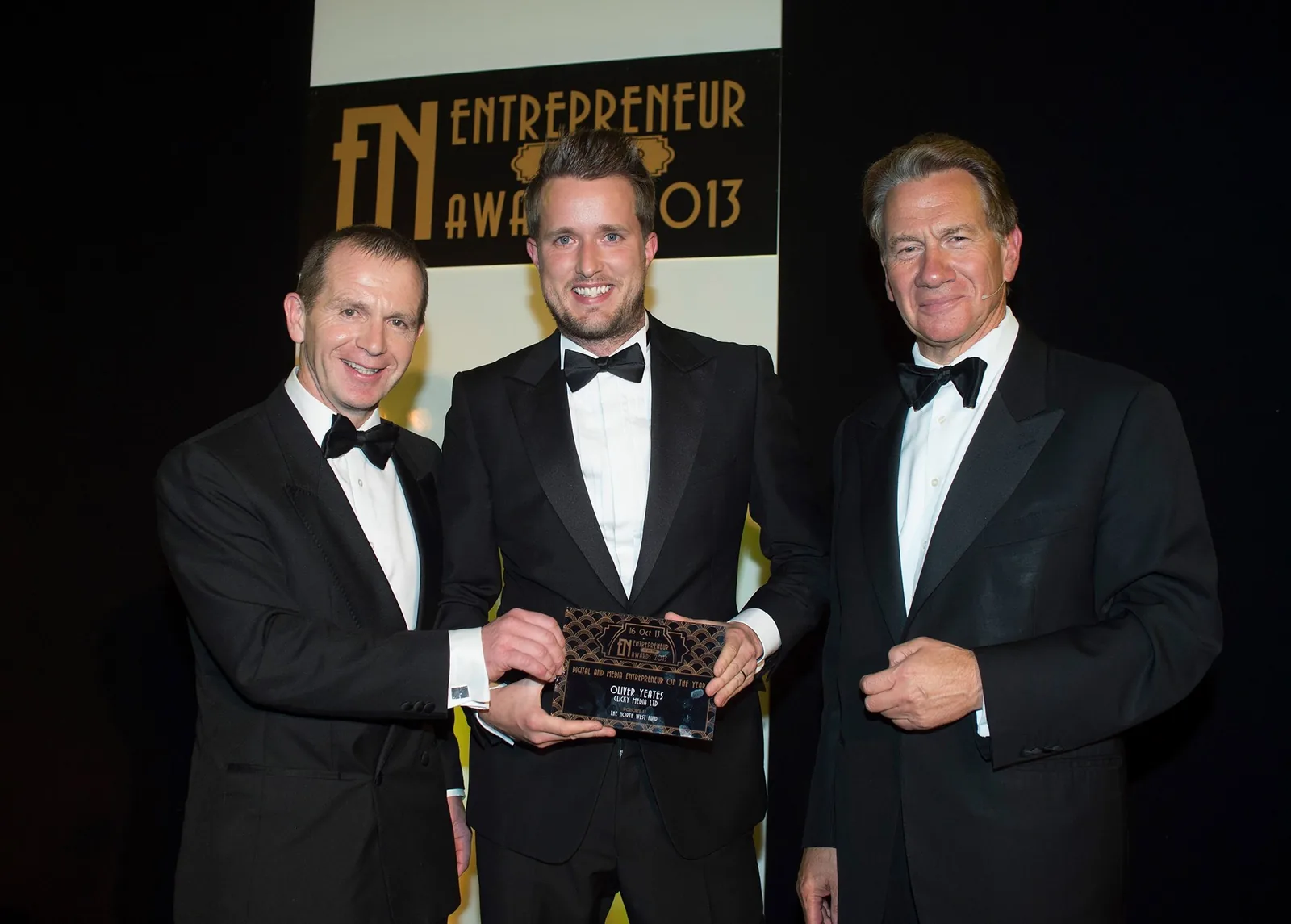 Oli collecting an Entrepreneur Awards 2013 trophy in black tie