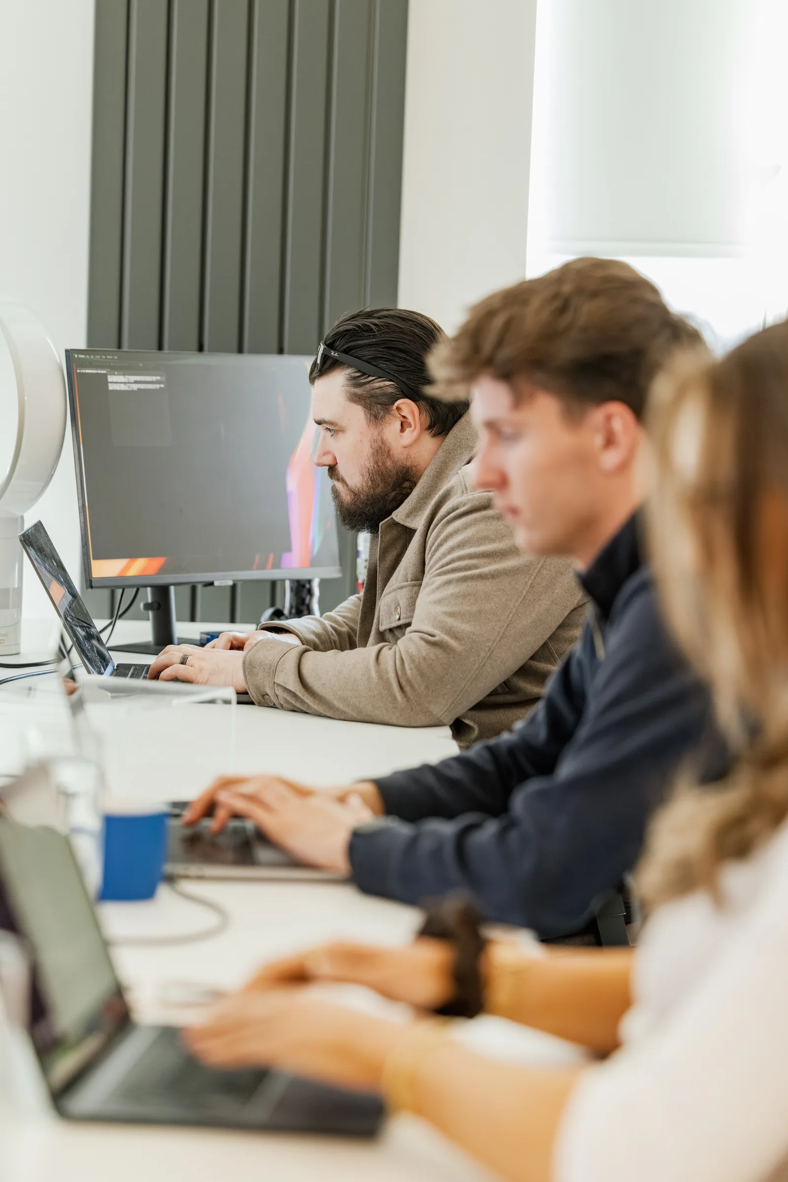 The team working at their desks in the studio