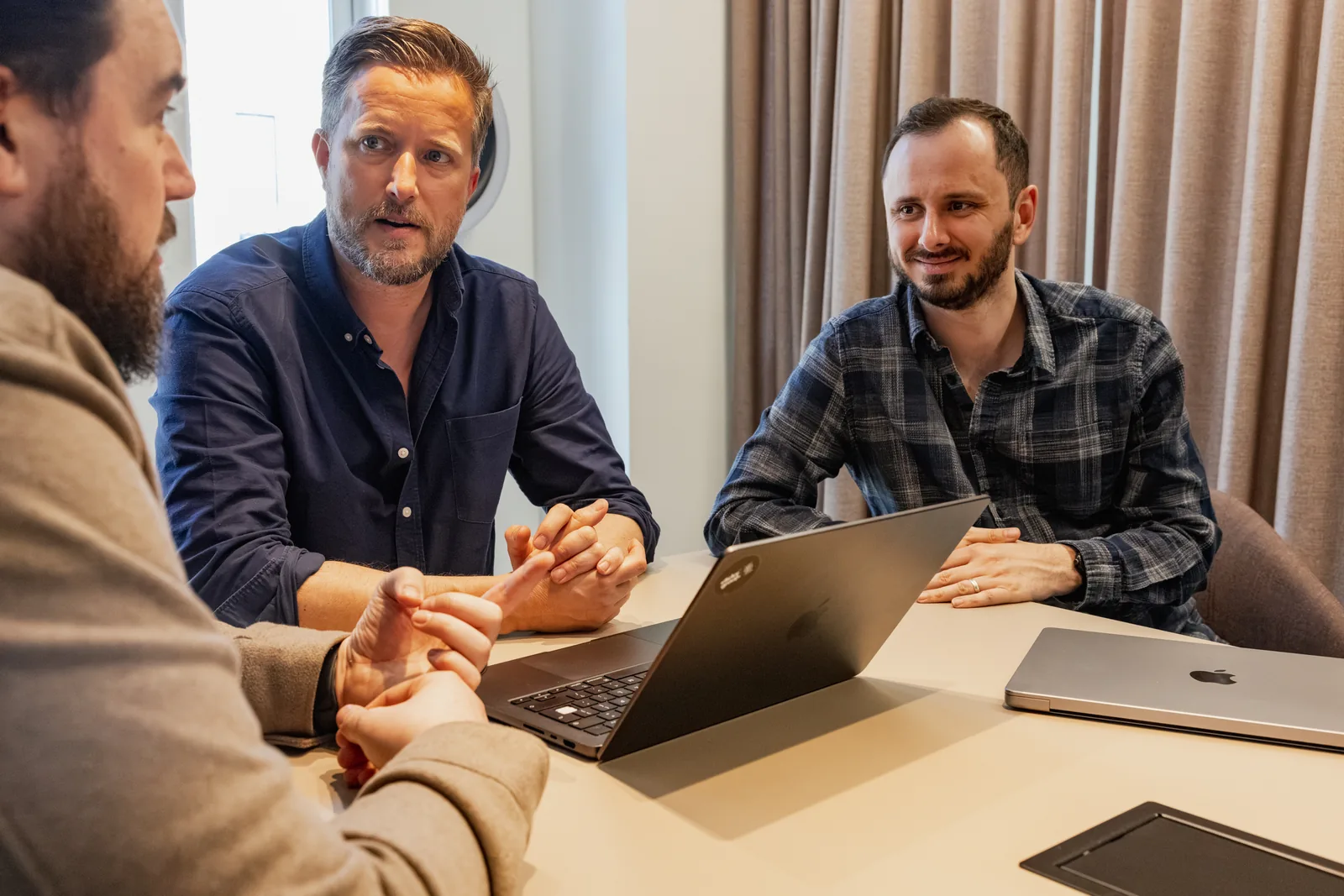 Three of the team in discussion in the studio